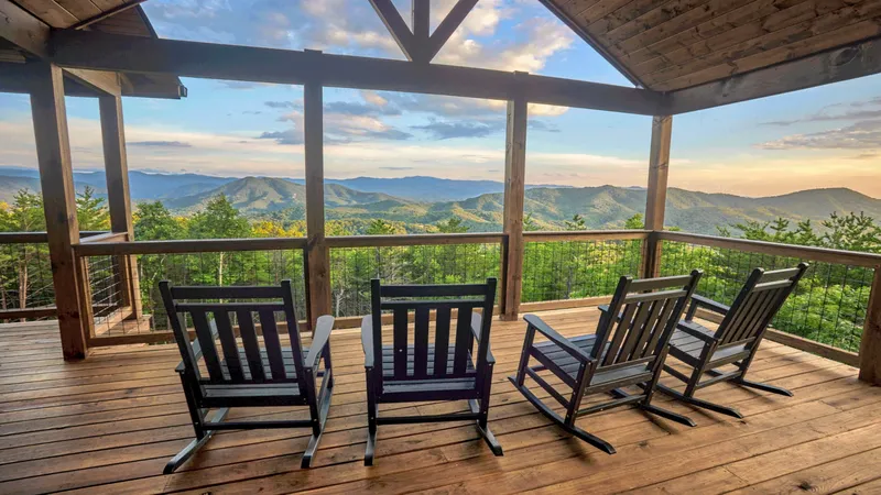 Rocking chairs on the covered deck of Thunderhead Mountain Lodge, Smoky Mountain ridges beyond