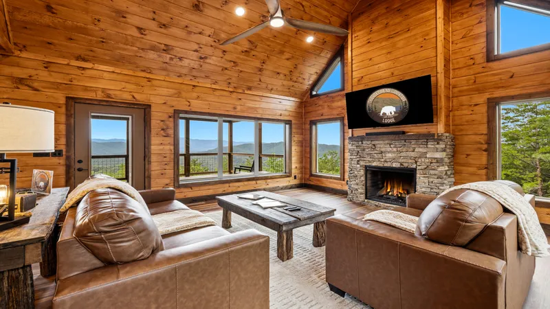 Great room with stone fireplace and mountain-view windows